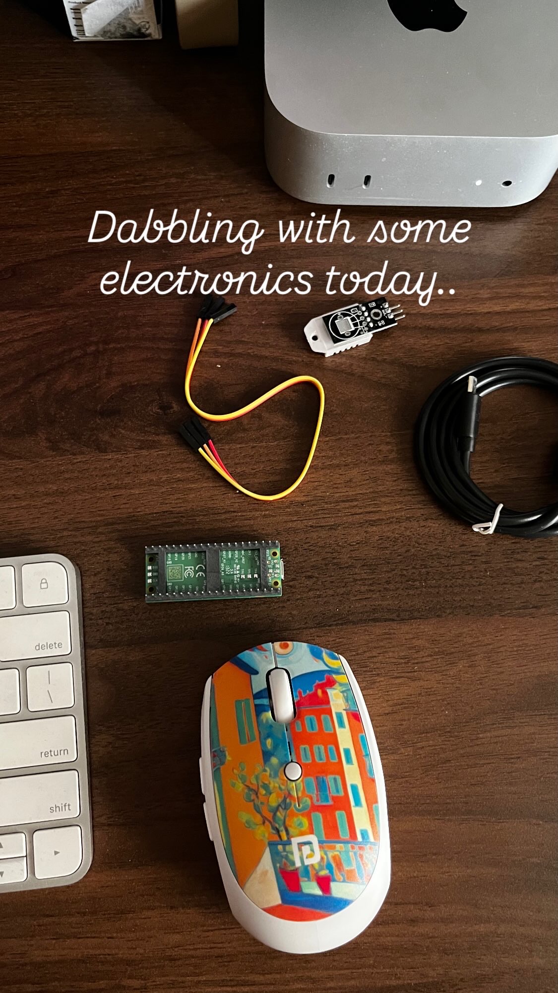Electronics components on a desk - Raspberry Pi Pico, DHT22 sensor, jumper wires